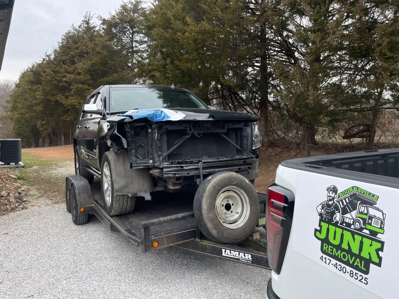 Rogersville Junk Removal hauling a junk car on a trailer in Rogersville MO